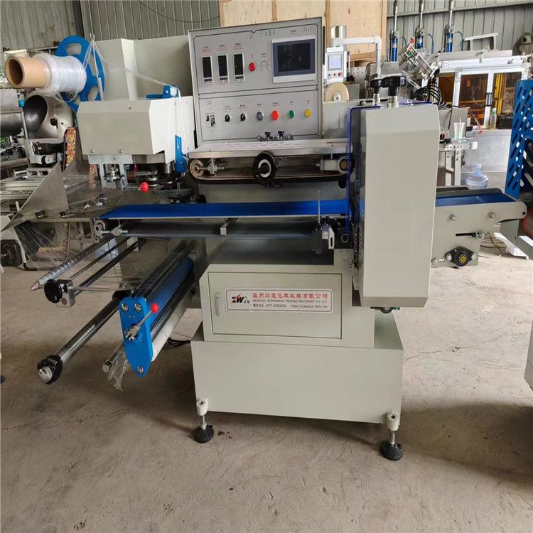 转让二手制热盒饭热缩膜枕式包装机 玉米滚动式包装机 立式液体包装机